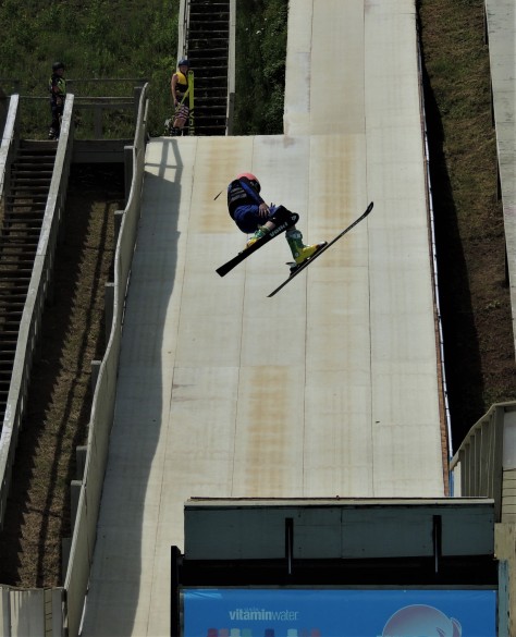 Freestyle skier twisting off the jump